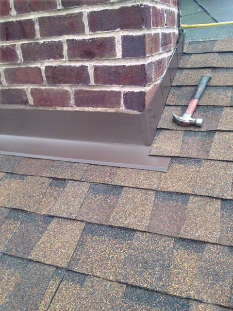 Chimney with new flashing and shingles after repair