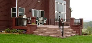 Composite deck with wide stairs off the back of a home